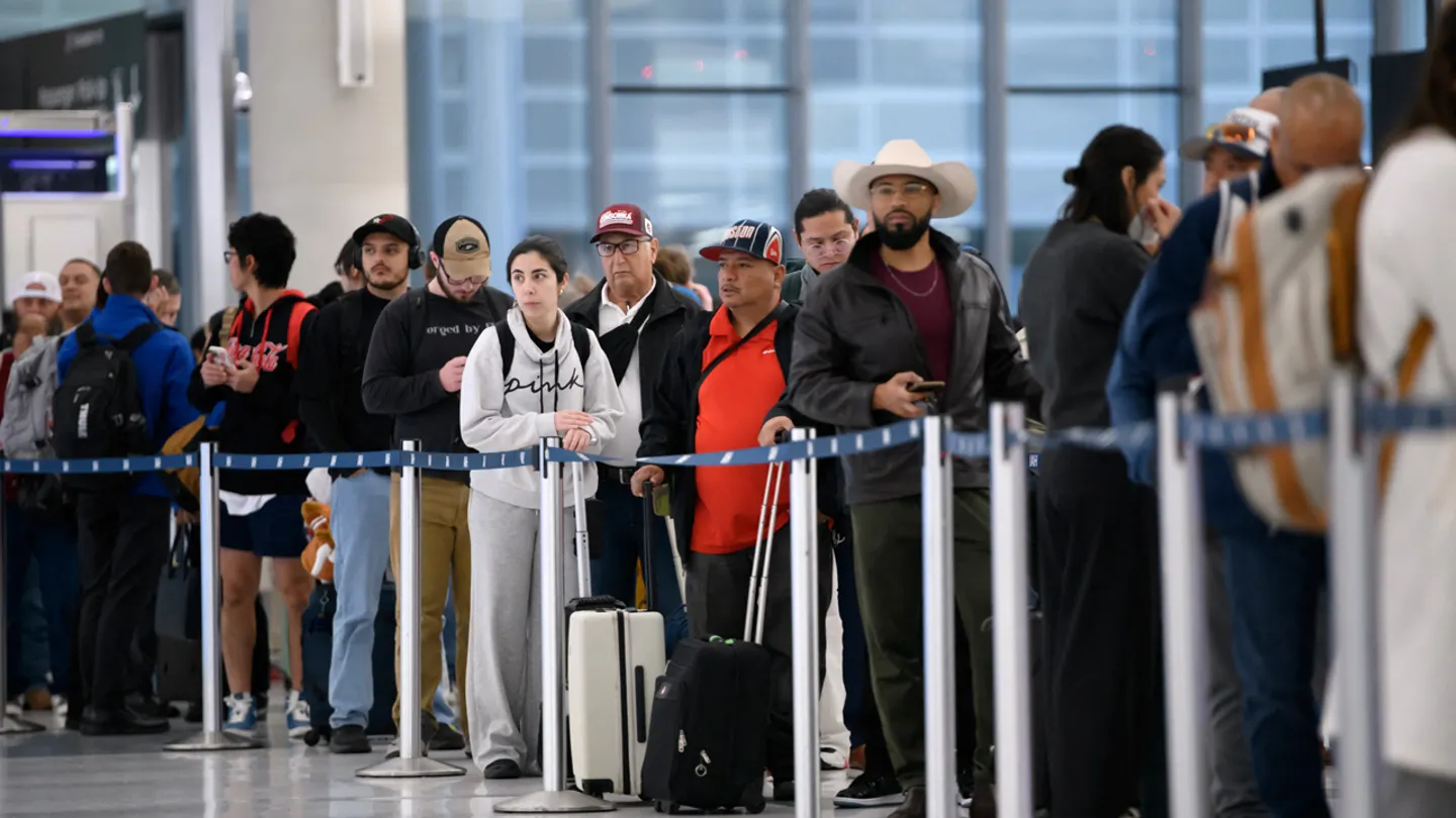 Travelers wait in long security lines at a U.S. airport as TSA staffing shortages during the government shutdown slow screenings